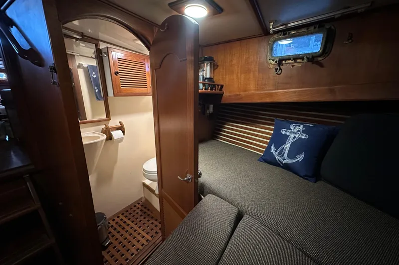 Slide: The Image of 1986 Present Yachts 35 MotorYacht interior with cozy cabin and compact bathroom. - 25