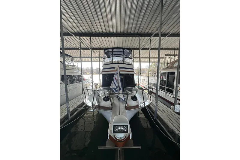 Slide: The Image of 1986 Present Yachts 35 MotorYacht docked in covered marina. - 3