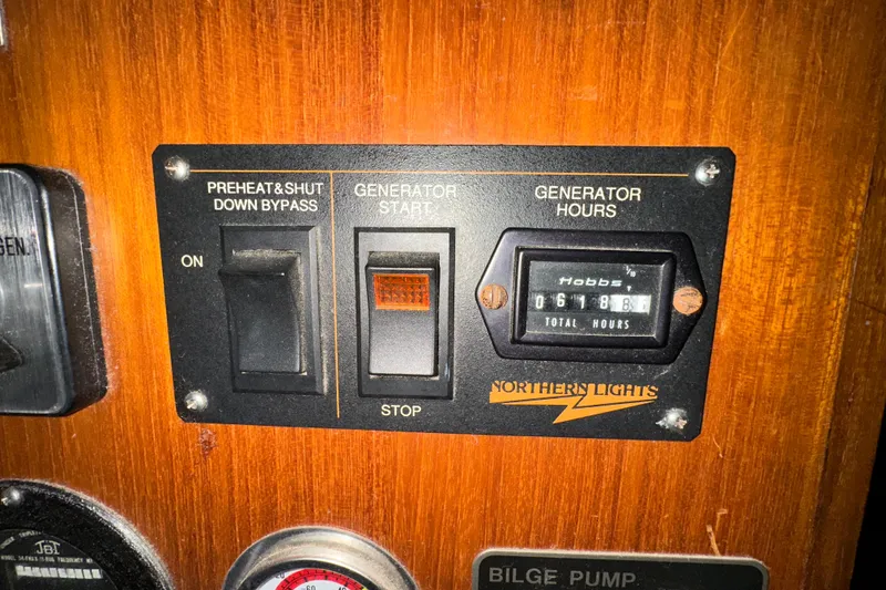 Slide: The Image of Control panel of 1986 Present Yachts 35 MotorYacht with generator switches and hour meter. - 31