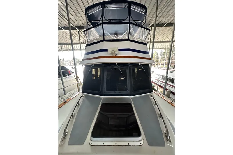 Slide: The Image of 1986 Present Yachts 35 MotorYacht docked in a covered marina. - 4