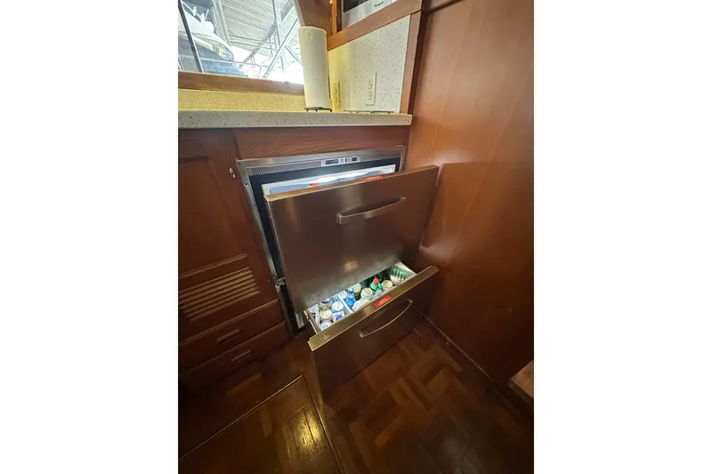 Slide: The Image of 1986 Present Yachts 35 MotorYacht interior with open stainless steel refrigerator drawers. - 13