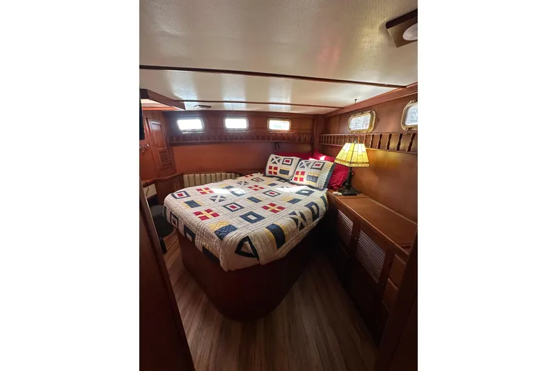 Slide: The Image of Cozy cabin interior of 1986 Present Yachts 35 MotorYacht with quilted bedspread. - 16