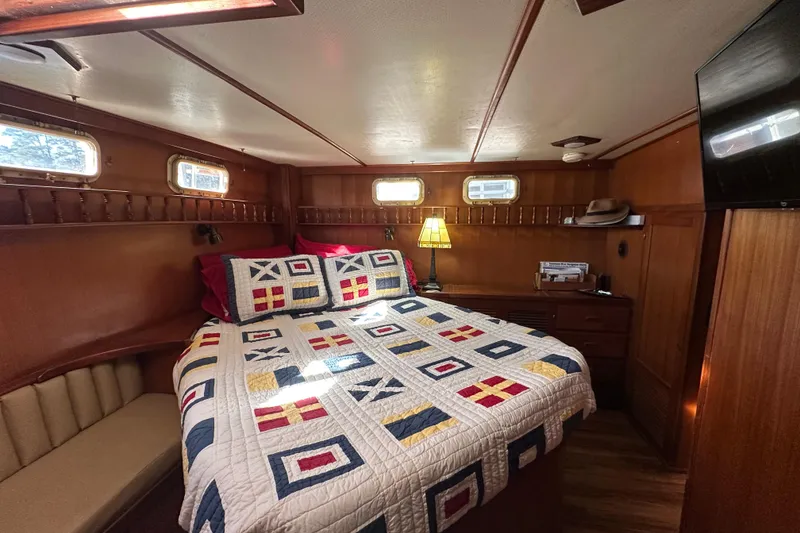 Slide: The Image of Cozy cabin interior of 1986 Present Yachts 35 MotorYacht with nautical-themed bedding. - 17
