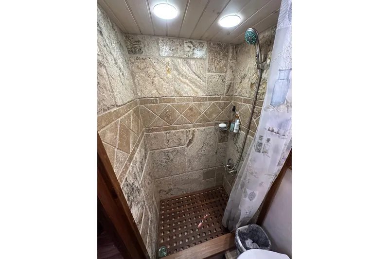 Slide: The Image of Luxurious stone-tiled shower in 1986 Present Yachts 35 MotorYacht bathroom. - 19
