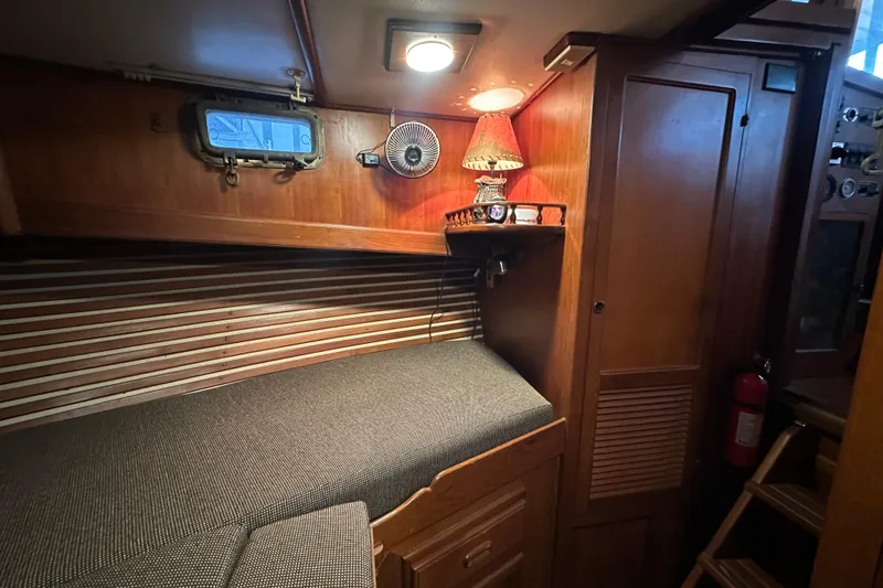 Slide: The Image of Cozy cabin interior of 1986 Present Yachts 35 MotorYacht with wooden furnishings. - 24