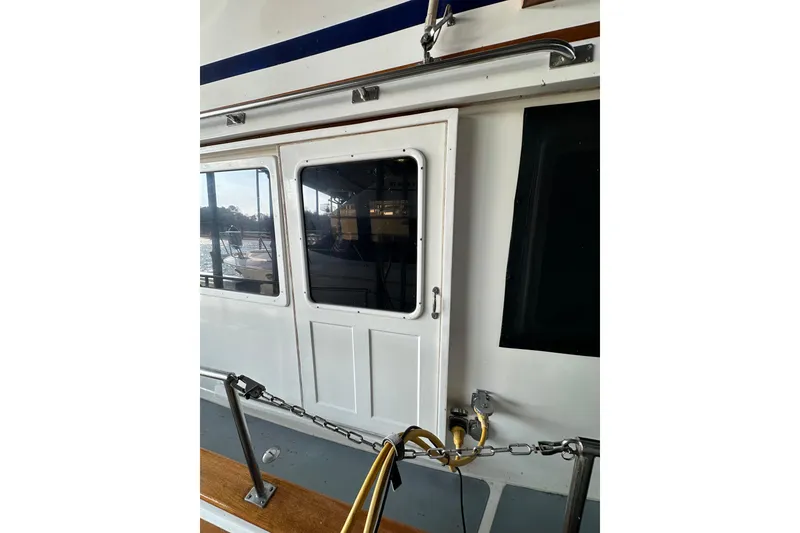 Slide: The Image of 1986 Present Yachts 35 MotorYacht exterior with door and railing detail. - 5