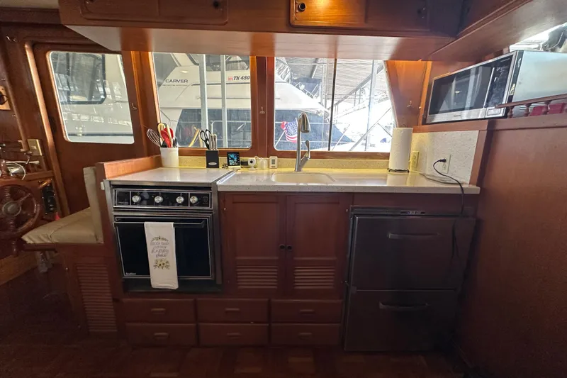 Slide: The Image of 1986 Present Yachts 35 MotorYacht kitchen with stove, sink, and microwave. - 9