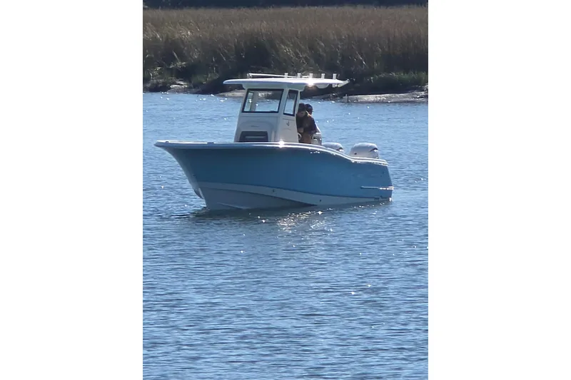 The Image of 2026 Pioneer boat on calm water, featuring a sleek blue hull and modern design. - 0