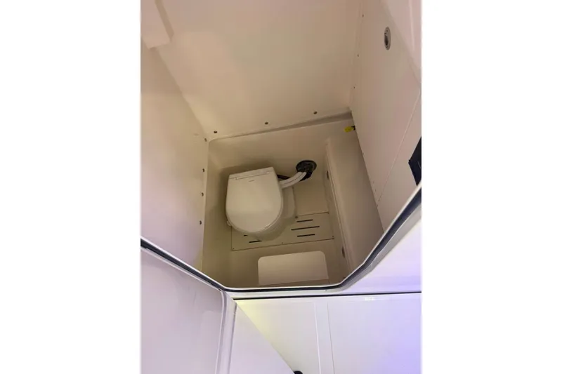 Slide: The Image of Interior view of 2026 Pioneer 250 Pelagic boat's compact bathroom with toilet. - 10
