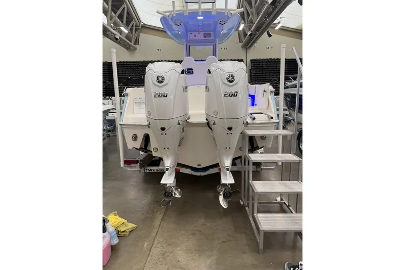 Slide: The Image of 2026 Pioneer 250 Pelagic boat with dual Yamaha 200 engines in showroom. - 5