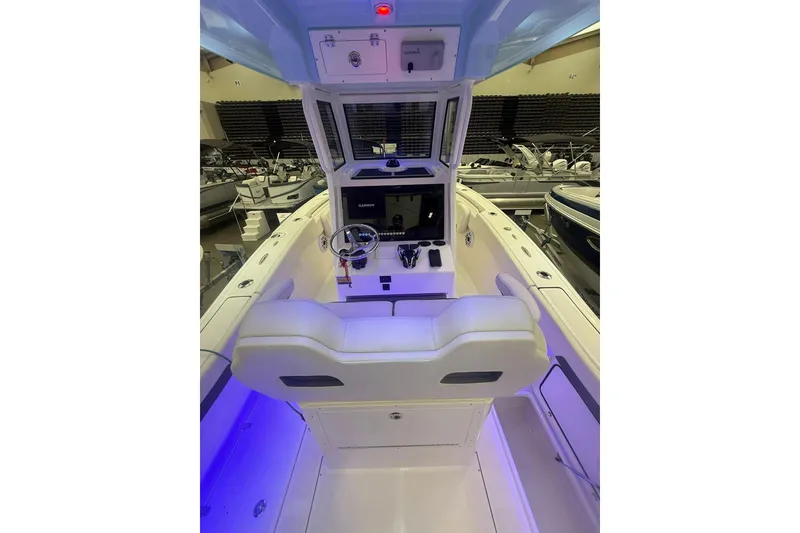 Slide: The Image of 2026 Pioneer 250 Pelagic boat interior with modern helm and seating. - 6