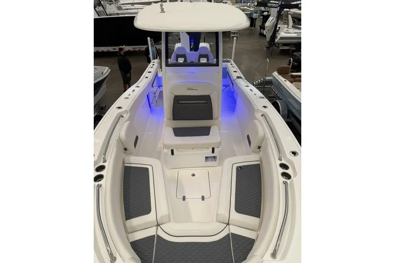 Slide: The Image of 2026 Pioneer 250 Pelagic boat interior with blue LED lighting and cushioned seating. - 7