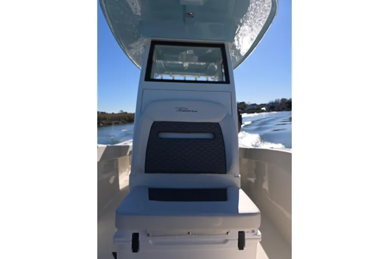 Slide: The Image of 2026 Pioneer boat interior with cushioned seating, navigating a sunny waterway. - 9