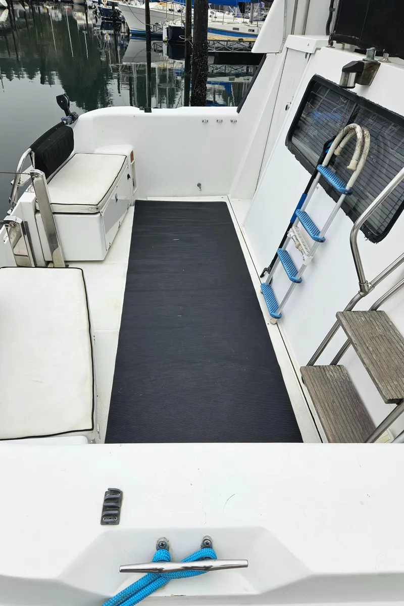 Slide: The Image of 1991 Tollycraft Euro Sport Sedan boat deck with seating and ladder. - 10