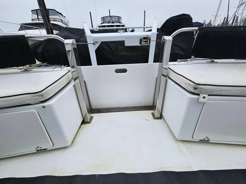 Slide: The Image of 1991 Tollycraft Euro Sport Sedan boat deck with seating and railing. - 11