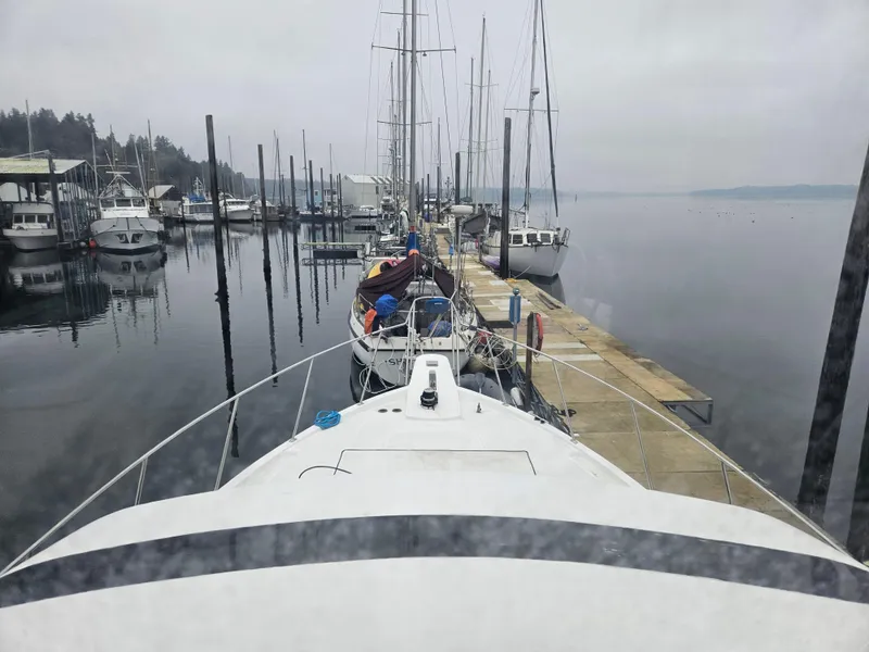 Slide: The Image of 1991 Tollycraft Euro Sport Sedan docked at a marina on a cloudy day. - 19