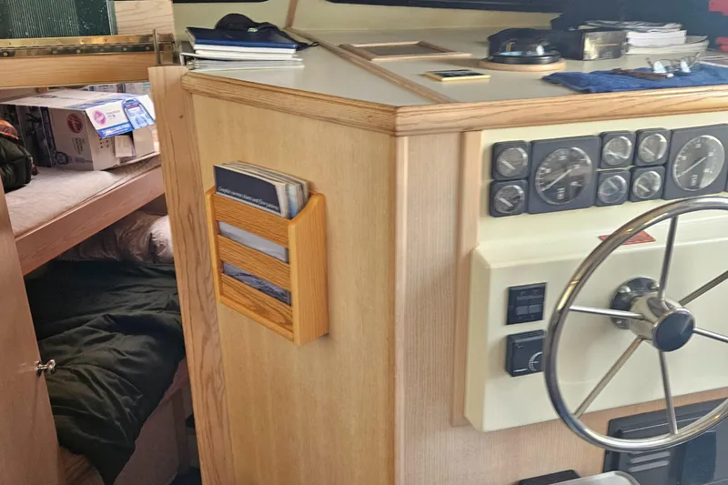 Slide: The Image of 1991 Tollycraft Euro Sport Sedan interior with steering wheel and control panel. - 23