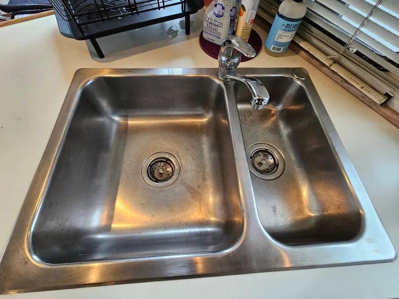 Slide: The Image of Stainless steel double sink with faucet on a Tollycraft Euro Sport Sedan, 1991 model. - 32