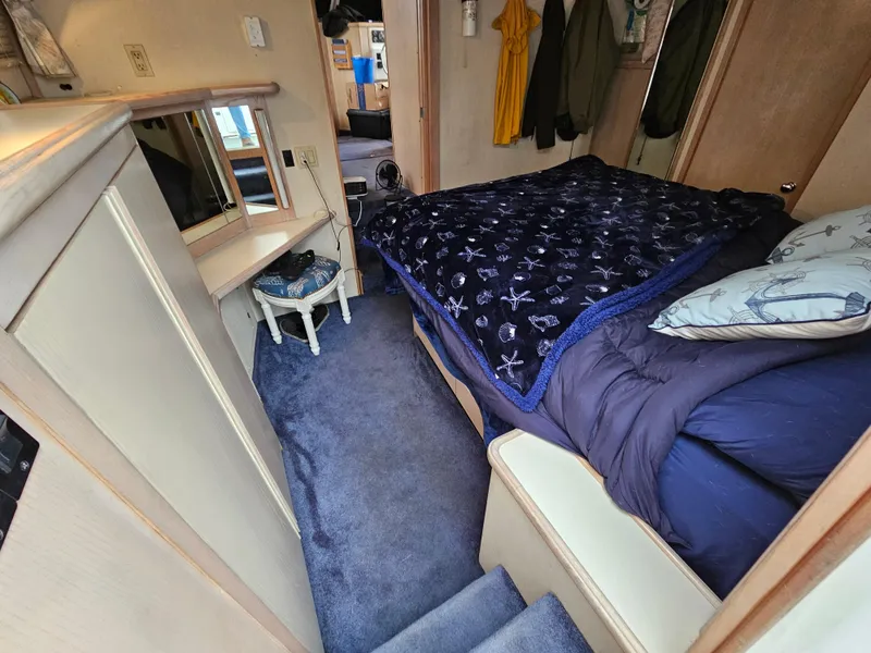 Slide: The Image of Interior of 1991 Tollycraft Euro Sport Sedan with cozy bedroom and blue carpet. - 37