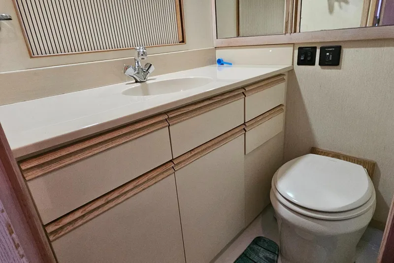 Slide: The Image of 1991 Tollycraft Euro Sport Sedan bathroom with sink, mirror, and toilet. - 44