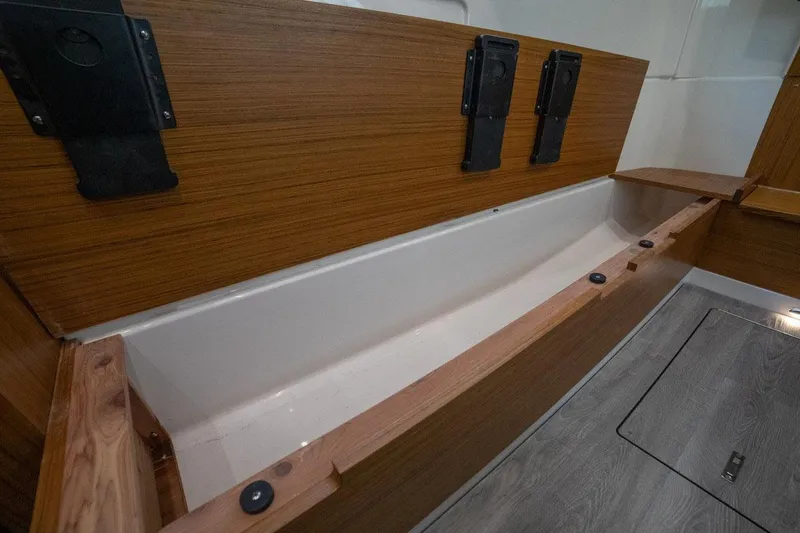 Slide: The Image of Manufacturer Provided Image: Interior storage compartment of 2022 Solace 41 CS boat with wooden finish. - 11
