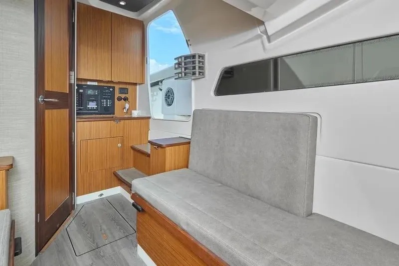 Slide: The Image of Interior of 2022 Solace 41 CS boat with wooden cabinetry and gray seating. - 19