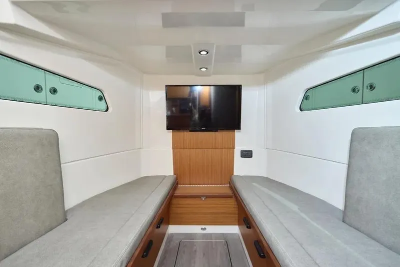 Slide: The Image of Interior of 2022 Solace 41 CS boat with modern seating and wall-mounted TV. - 21