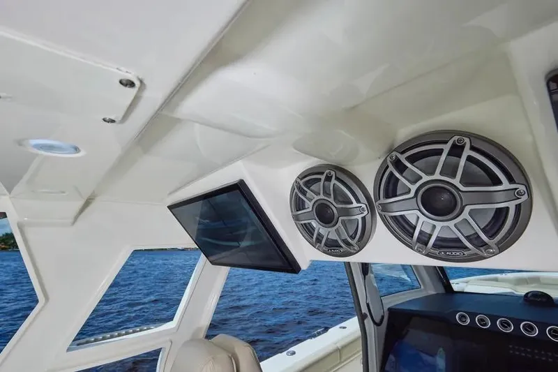 Slide: The Image of Interior of 2022 Solace 41 CS boat with speakers and screen, overlooking water. - 27