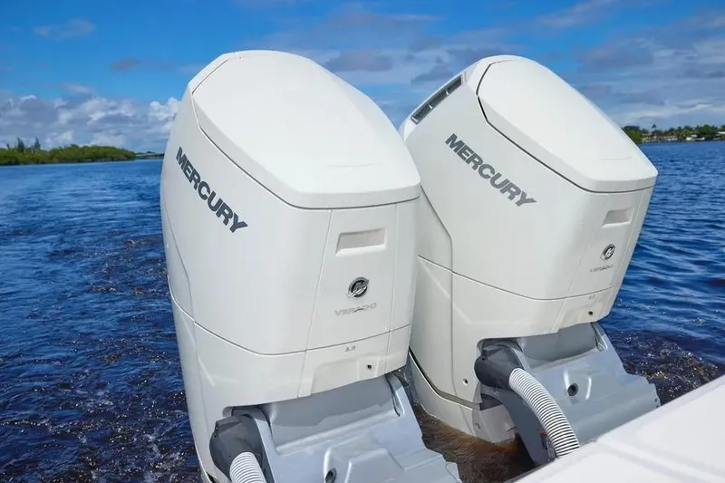 Slide: The Image of Twin Mercury outboard engines on a 2022 Solace 41 CS boat in open water. - 34