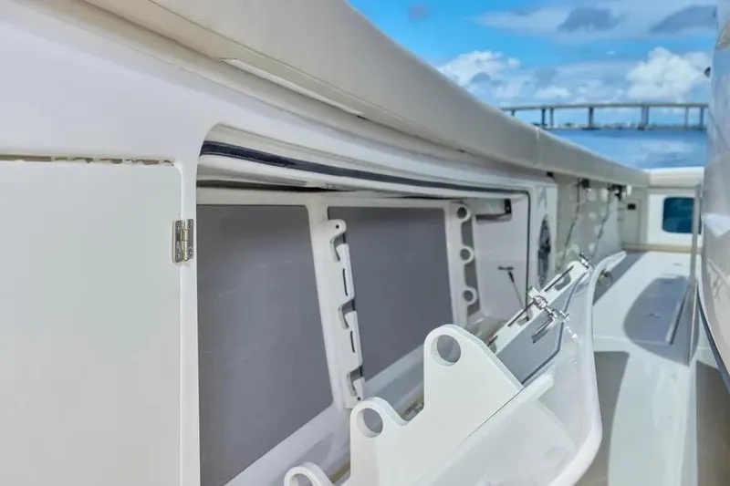 Slide: The Image of 2022 Solace 41 CS boat interior with open storage compartment, under a clear blue sky. - 36