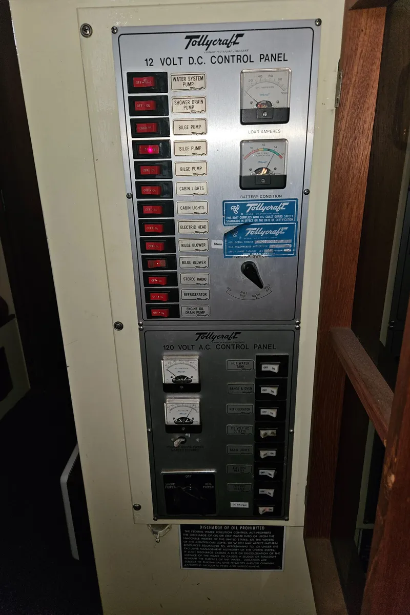 Slide: The Image of 1978 Tollycraft 37 Sport Sedan 12-volt DC control panel with switches and meters. - 18
