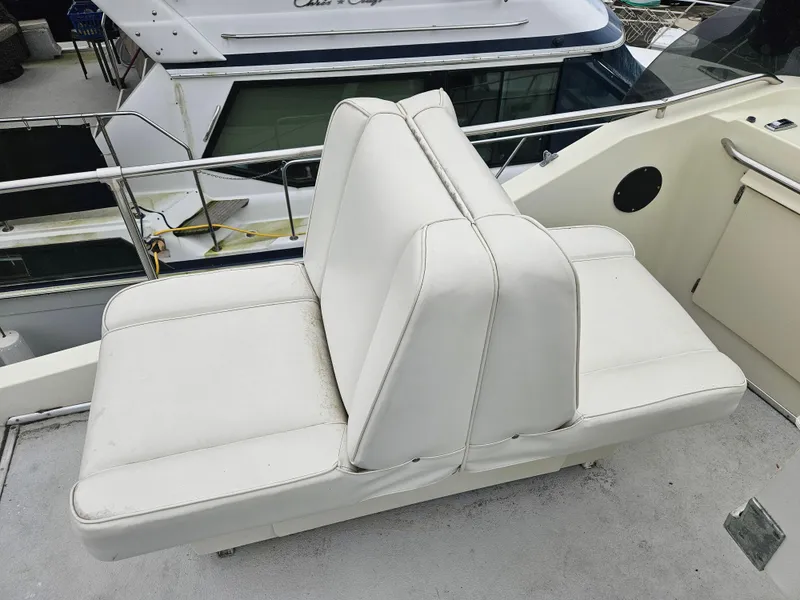 Slide: The Image of 1978 Tollycraft 37 Sport Sedan boat with white cushioned seating on deck. - 28