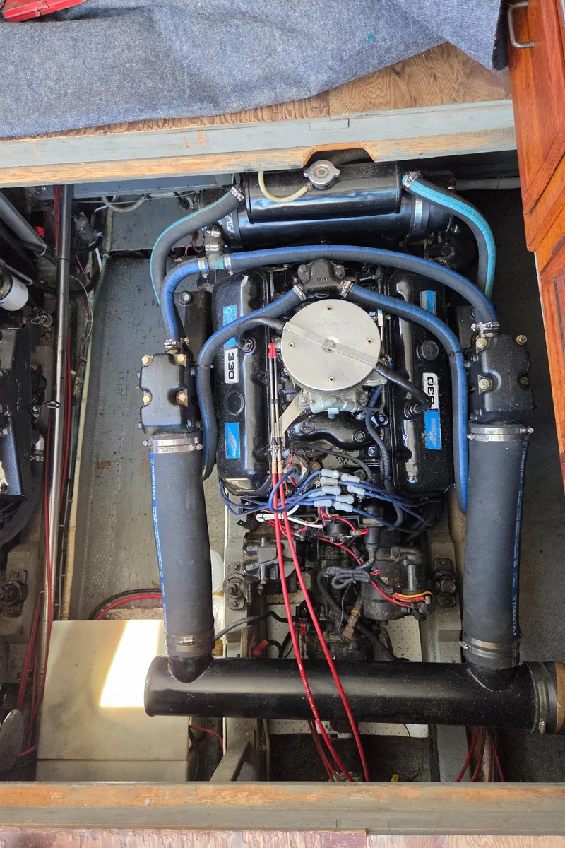 Slide: The Image of Engine compartment of a 1978 Tollycraft 37 Sport Sedan boat, showcasing detailed mechanical components. - 38