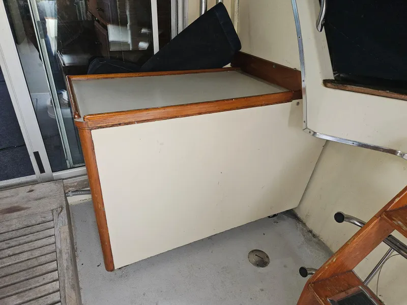 Slide: The Image of 1978 Tollycraft 37 Sport Sedan interior with wooden cabinetry and seating area. - 5