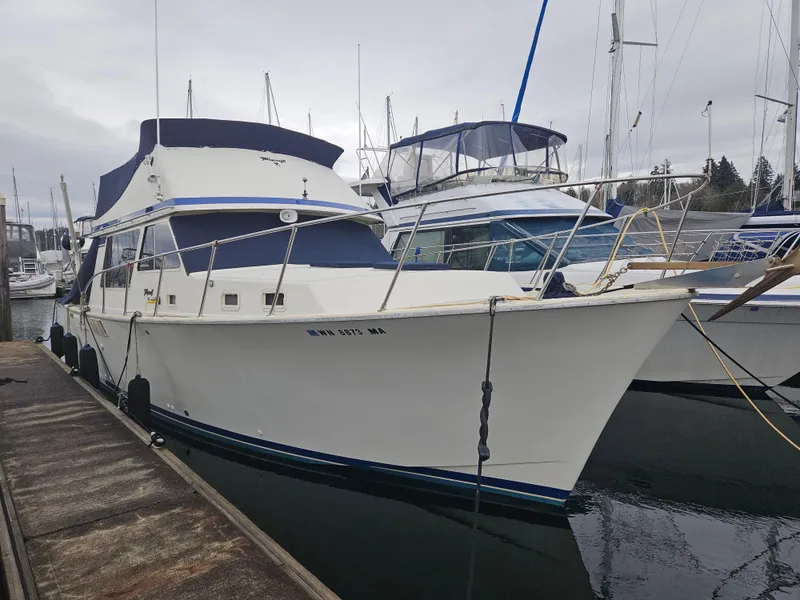 Slide: The Image of 1978 Tollycraft 37 Sport Sedan docked at marina, overcast sky. - 1