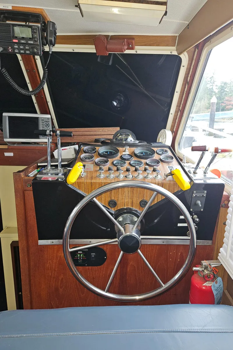 Slide: The Image of 1978 Tollycraft 37 Sport Sedan helm with steering wheel and navigation instruments. - 14