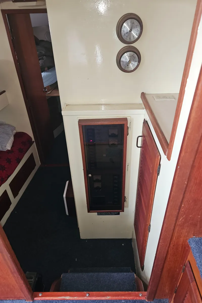 Slide: The Image of Interior of 1978 Tollycraft 37 Sport Sedan with control panel and cozy cabin space. - 17