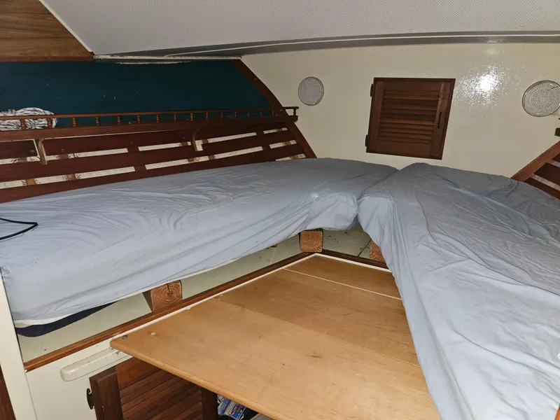 Slide: The Image of 1978 Tollycraft 37 Sport Sedan cabin interior with wooden accents and bed. - 19