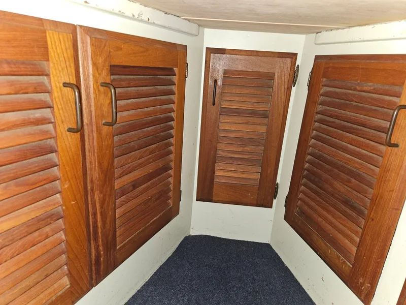 Slide: The Image of 1978 Tollycraft 37 Sport Sedan interior with wooden louvered cabinets. - 20