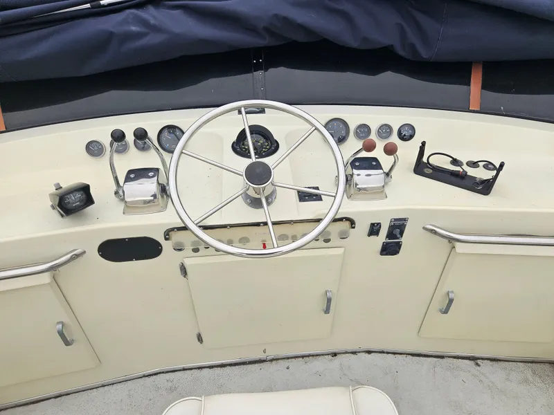 Slide: The Image of 1978 Tollycraft 37 Sport Sedan helm with steering wheel and control panel. - 22