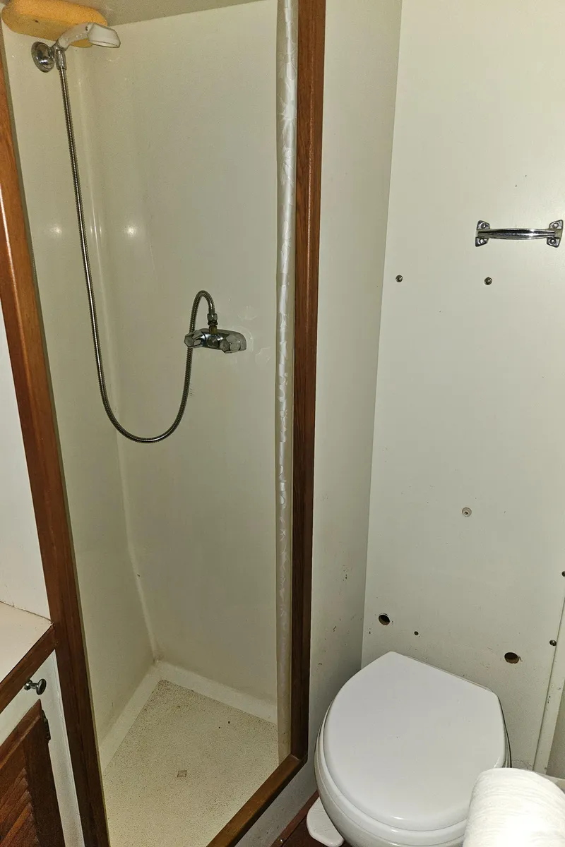 Slide: The Image of 1978 Tollycraft 37 Sport Sedan bathroom with shower and toilet. - 23
