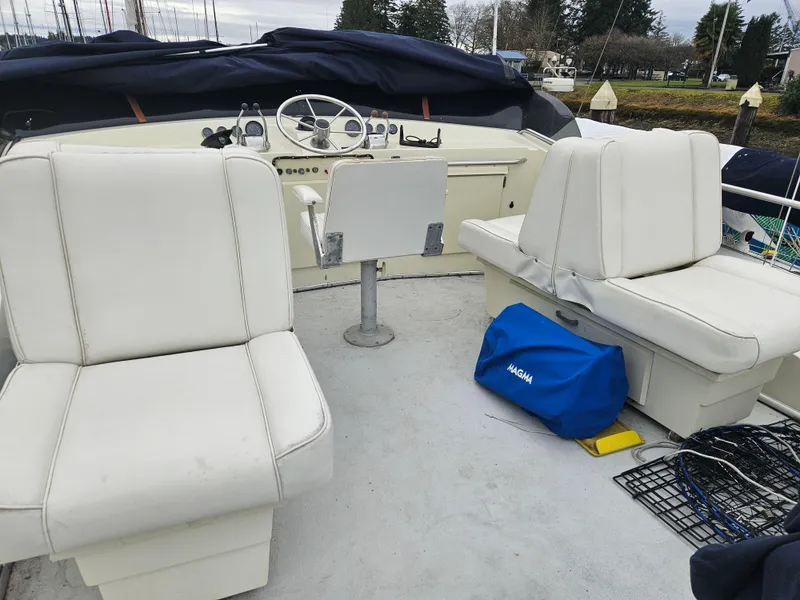 Slide: The Image of 1978 Tollycraft 37 Sport Sedan boat interior with white seating and steering wheel. - 26