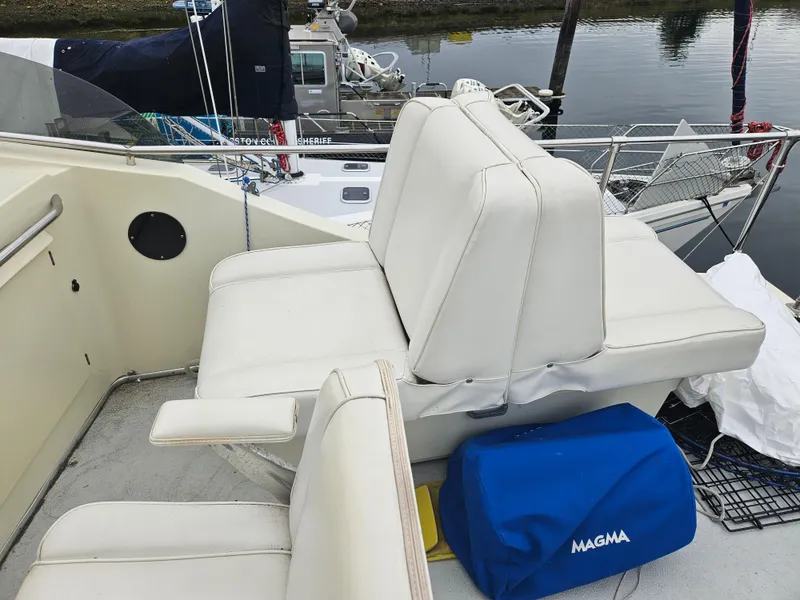 Slide: The Image of 1978 Tollycraft 37 Sport Sedan boat with white seating and a blue Magma cover. - 27