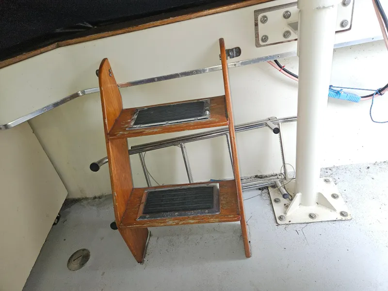 Slide: The Image of Wooden steps on a 1978 Tollycraft 37 Sport Sedan boat interior. - 30