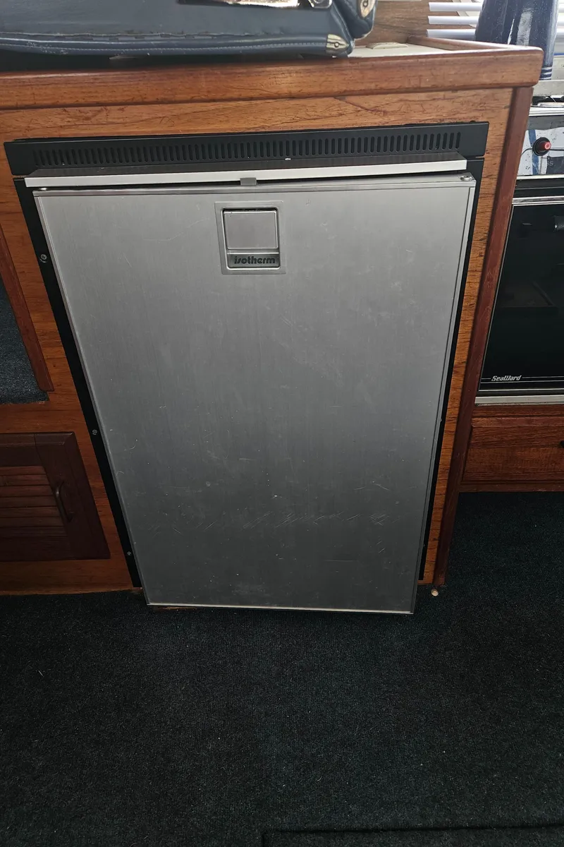 Slide: The Image of 1978 Tollycraft 37 Sport Sedan interior with a compact refrigerator. - 32