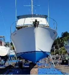 Slide: The Image of 1978 Tollycraft 37 Sport Sedan boat on dry dock, blue sky background. - 4