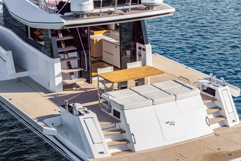 Slide: The Image of 2023 Pardo Yachts E60 luxury yacht deck with seating and dining area. - 1