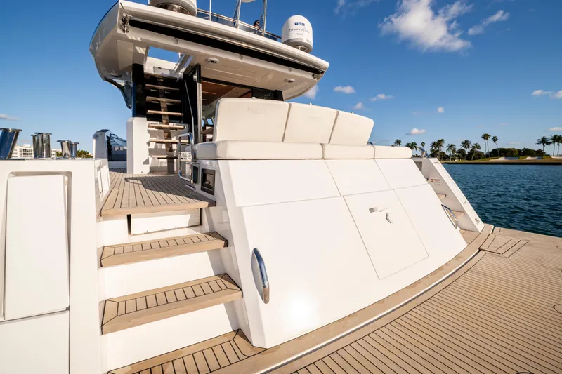 Slide: The Image of 2023 Pardo Yachts E60 luxury yacht on serene water, showcasing elegant design and spacious deck. - 19