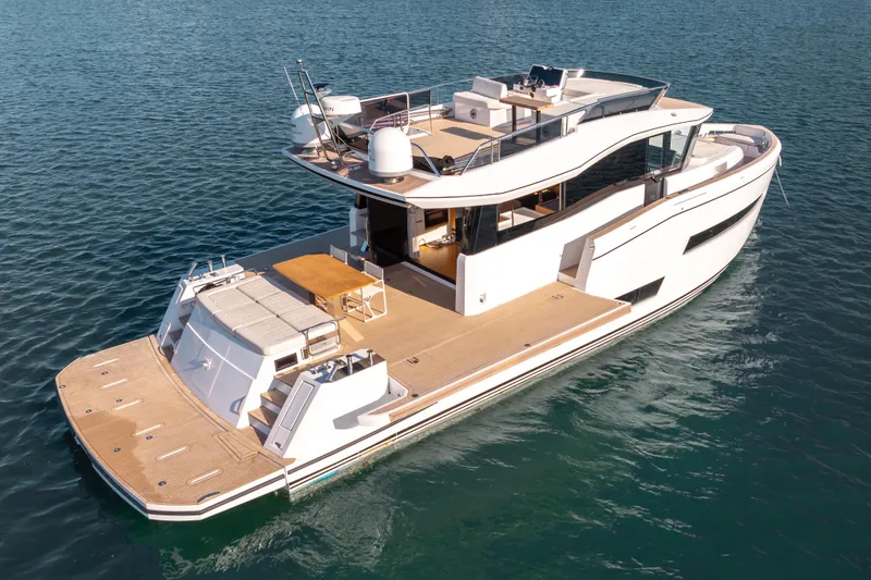 Slide: The Image of 2023 Pardo Yachts E60 cruising on a sunny day near waterfront homes. - 2