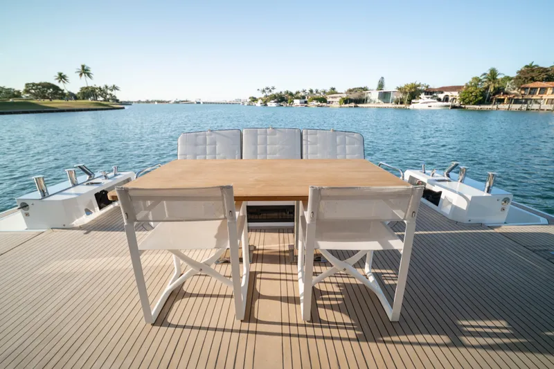 Slide: The Image of 2023 Pardo Yachts E60 luxury yacht deck with stairs and seating, ocean view. - 20